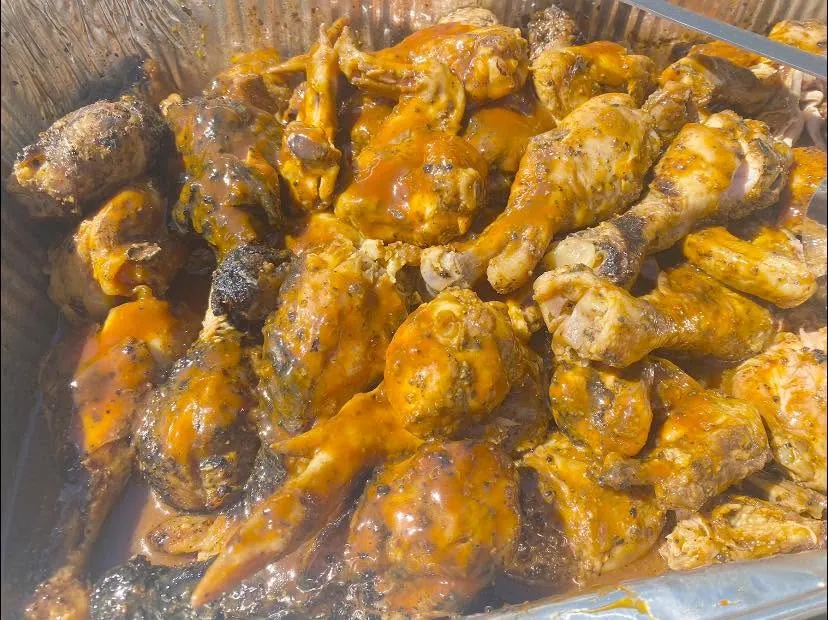 A tray of barbecue chicken for a street feeding
